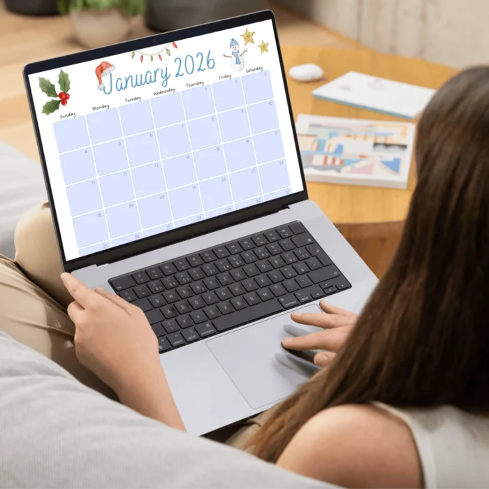 Person working on a laptop displaying a fillable January 2026 calendar PDF with blue date fields and winter-themed graphics.
