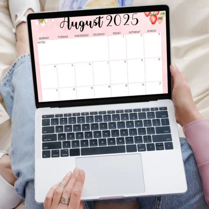 Woman using August 2025 printable calendar on laptop