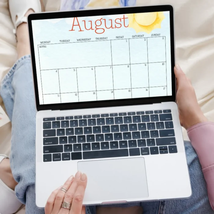 Person using August calendar on a laptop